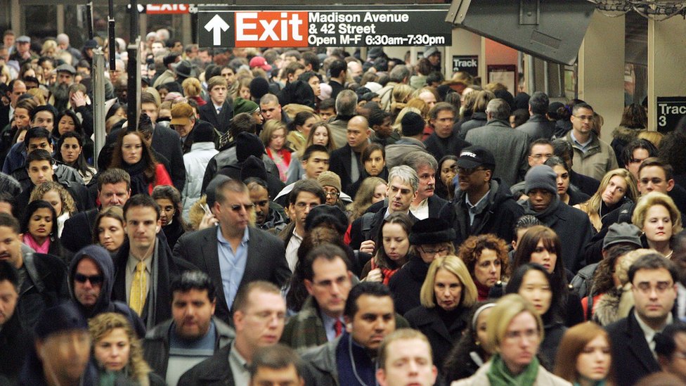 Multitud caminando en una estación de metro.