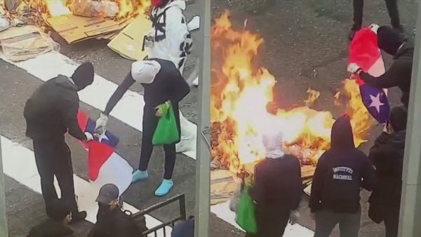 Encapuchados queman bandera chilena en medio de incidentes frente al Instituto Nacional