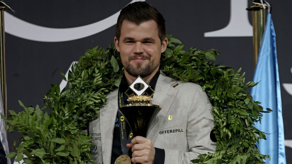 Magnus Carlsen en 2021 con su trofeo de campeón del mundo