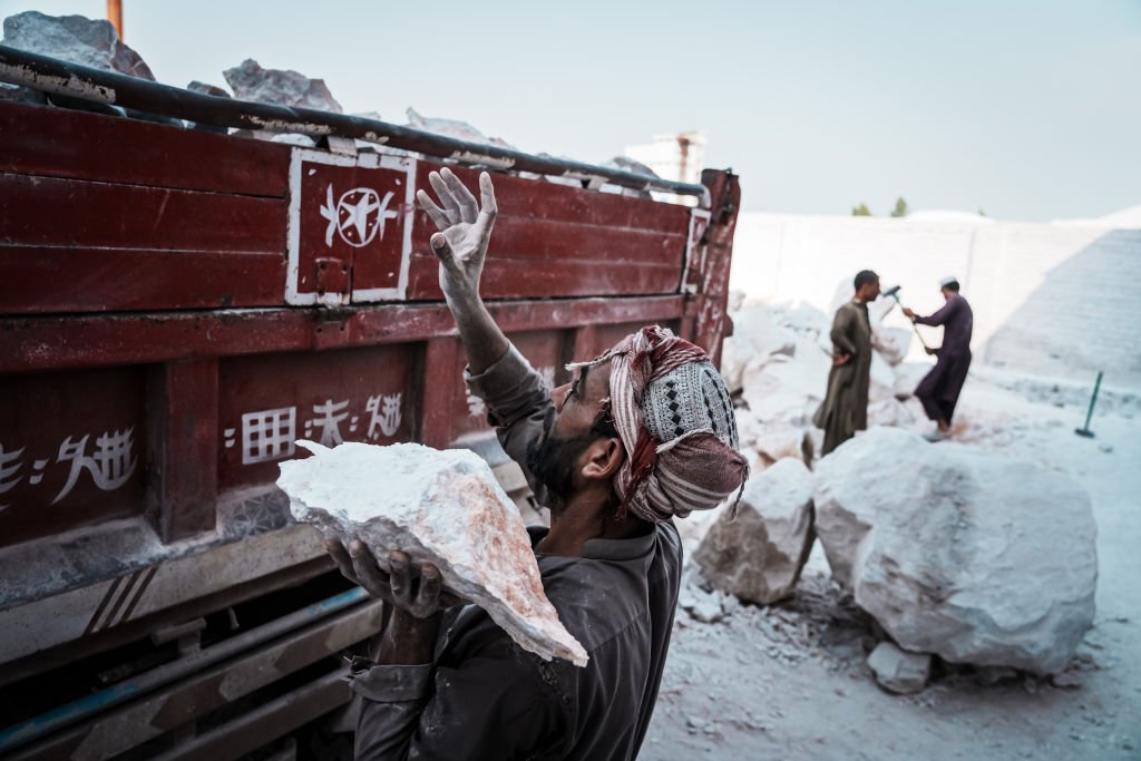 Hombre afgano carga rocas en un camión