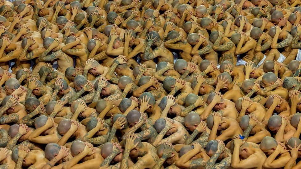 Gang members wait to be taken to their cells after 2000 gang members were transferred to the Terrorism Confinement Center