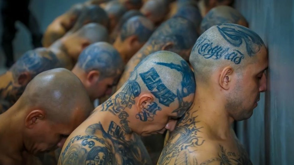 Gang members wait to be taken to their cells after 2000 gang members were transferred to the Terrorism Confinement Center