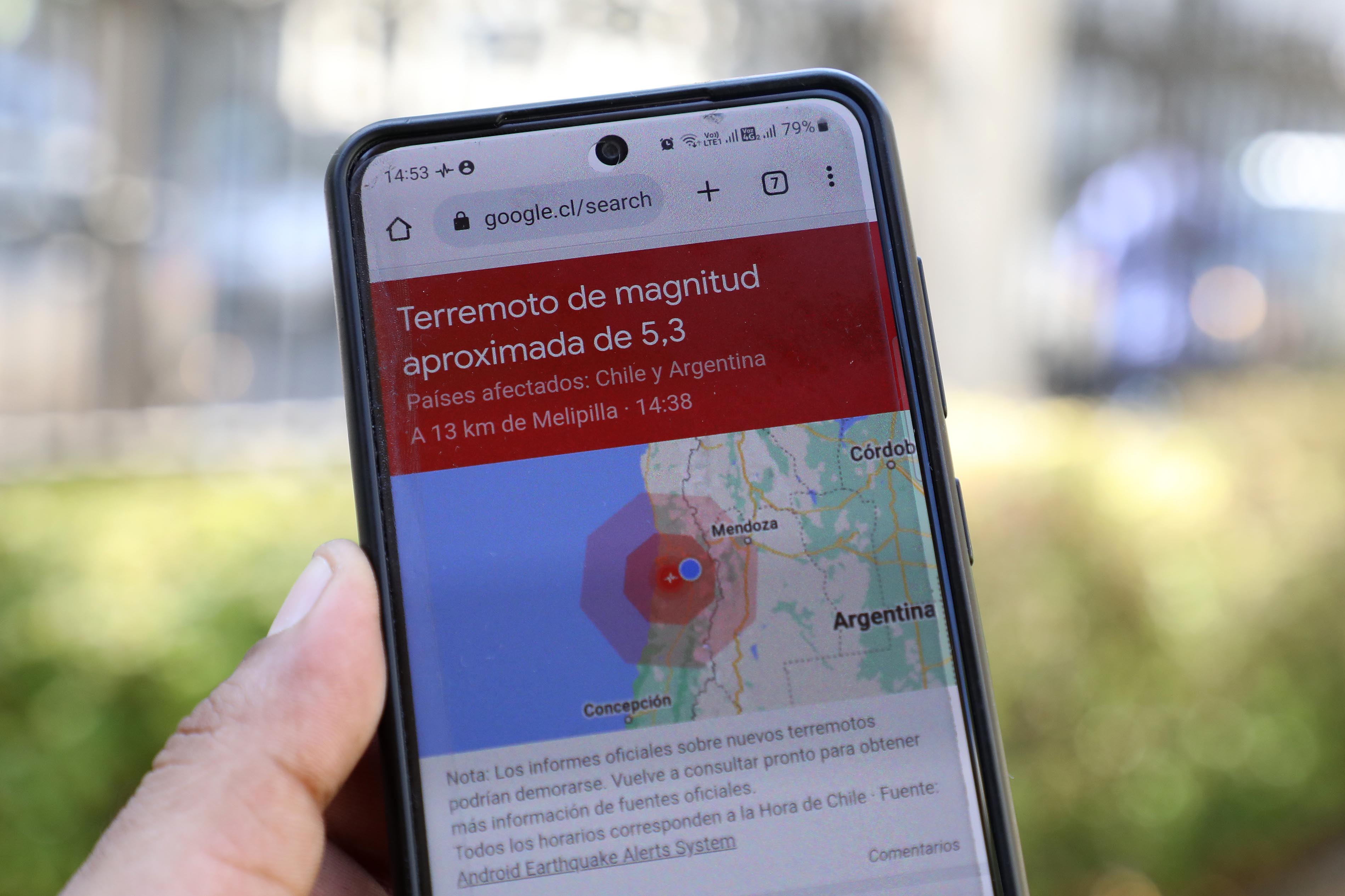 Imagen de un celular con información sobre un sismo en pantalla.