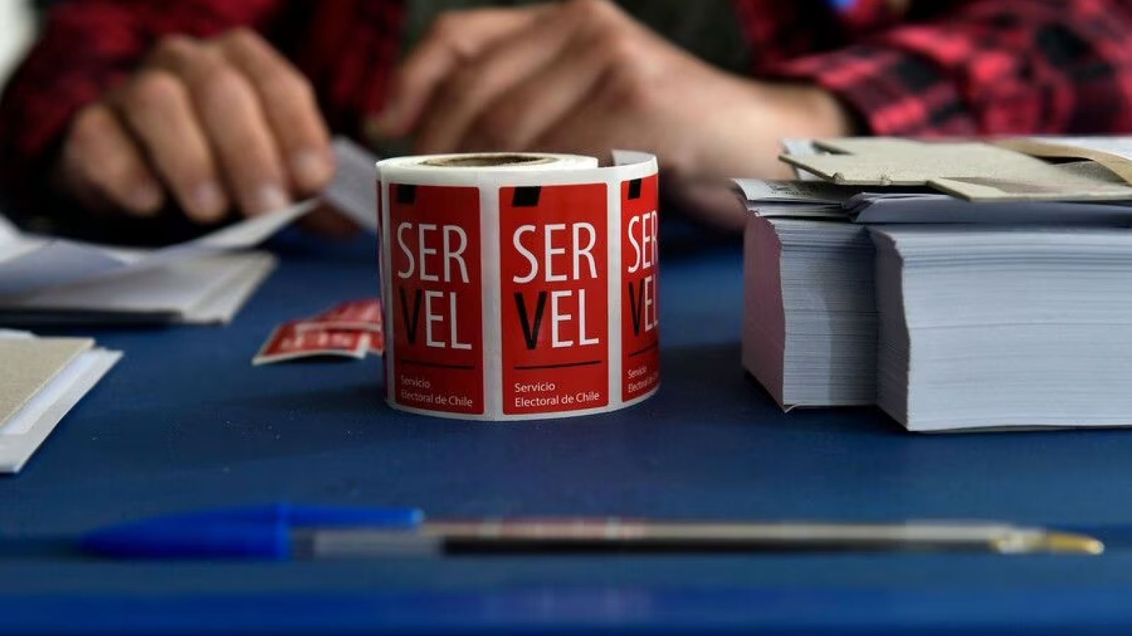 Rollo de stickers del Servel para sellar votos sobre una mesa