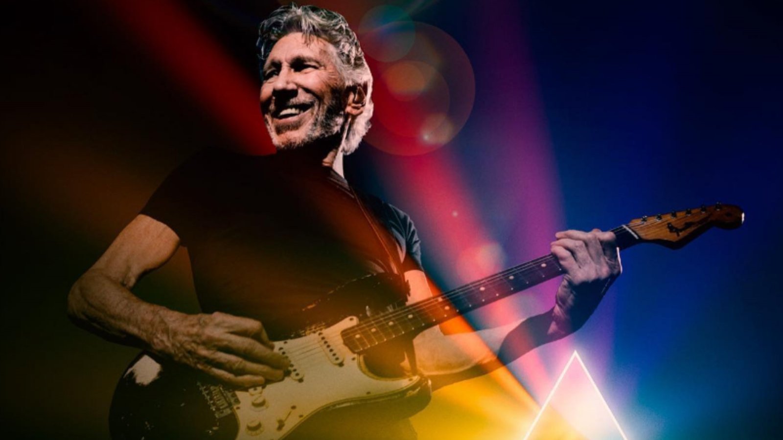 Roger Waters con una guitarra sobre el escenario.