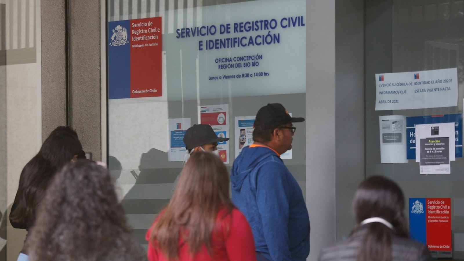 Personas haciendo fila en una oficina del Registro Civil.