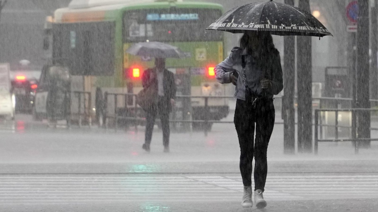 Mujer caminando bajo la lluvia en Japón.