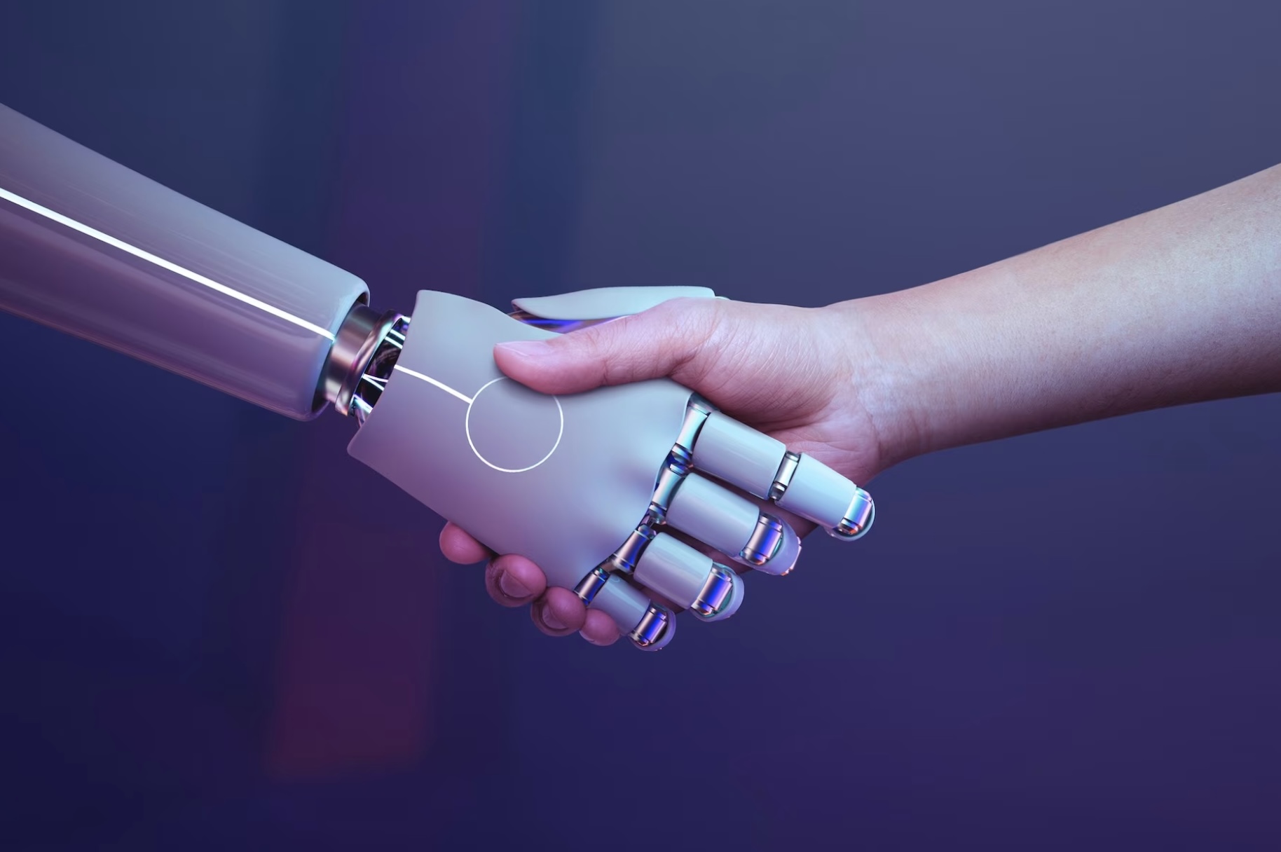 Mano humana dándole la mano a una mano robot