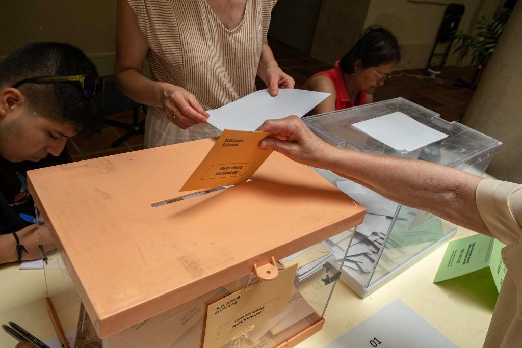 Una mujer deposita su voto en las elecciones españolas