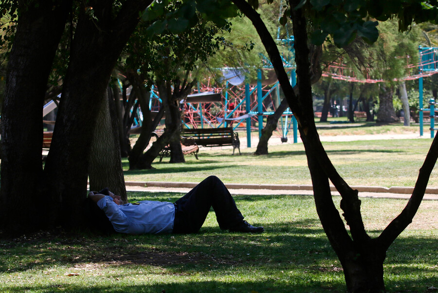 Persona descansando del calor ne una plaza