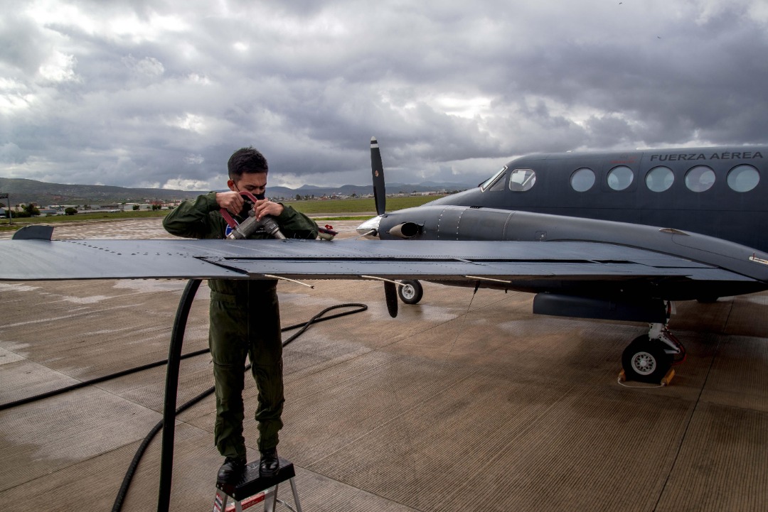 Un piloto recarga de combustible un ala de una aeronave de la FAM