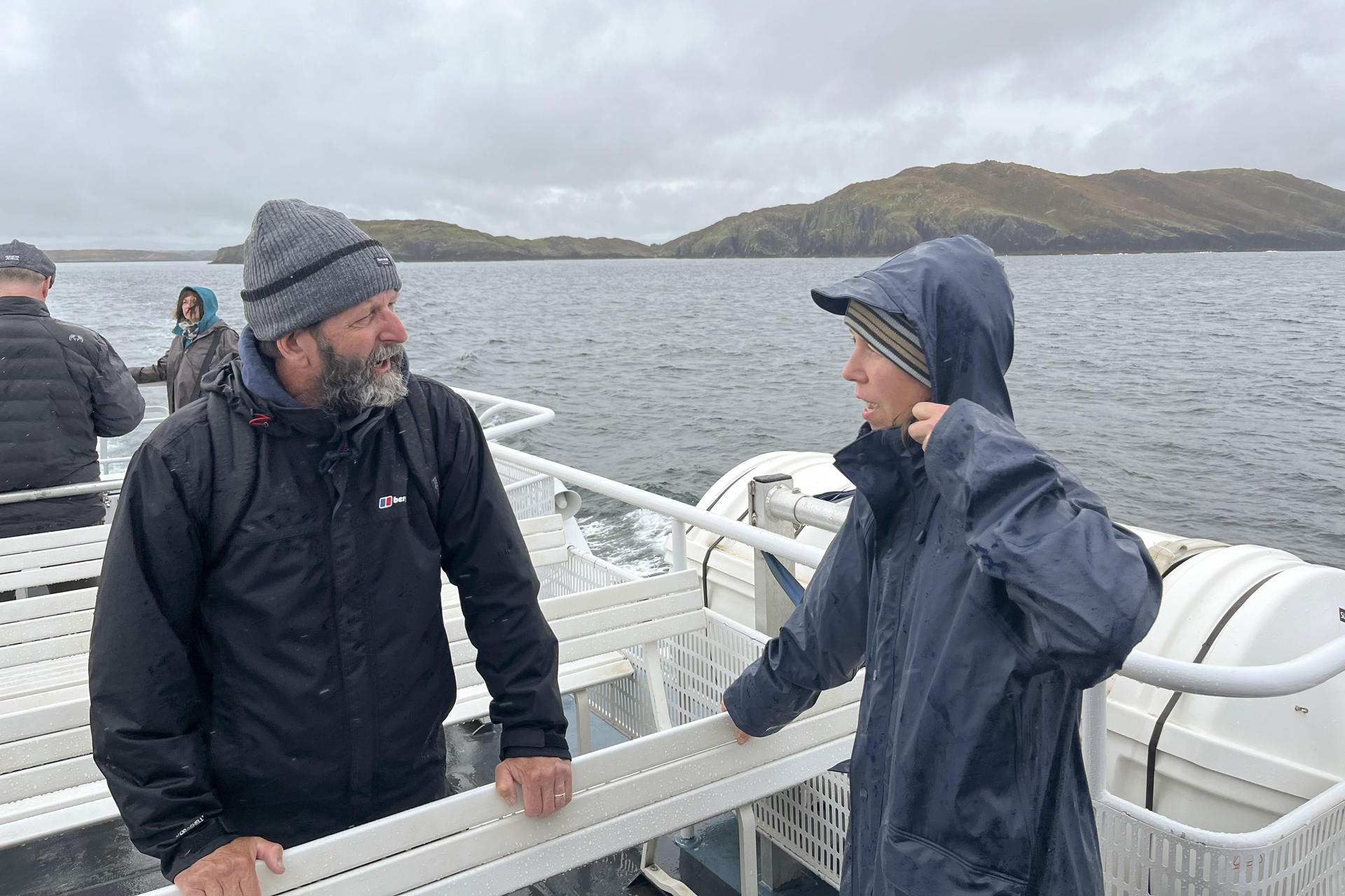Two participants converse during a boat tour around the Celtic Sea, organized to introduce a project that uses AI to protect cetaceans along the coasts of Ireland.