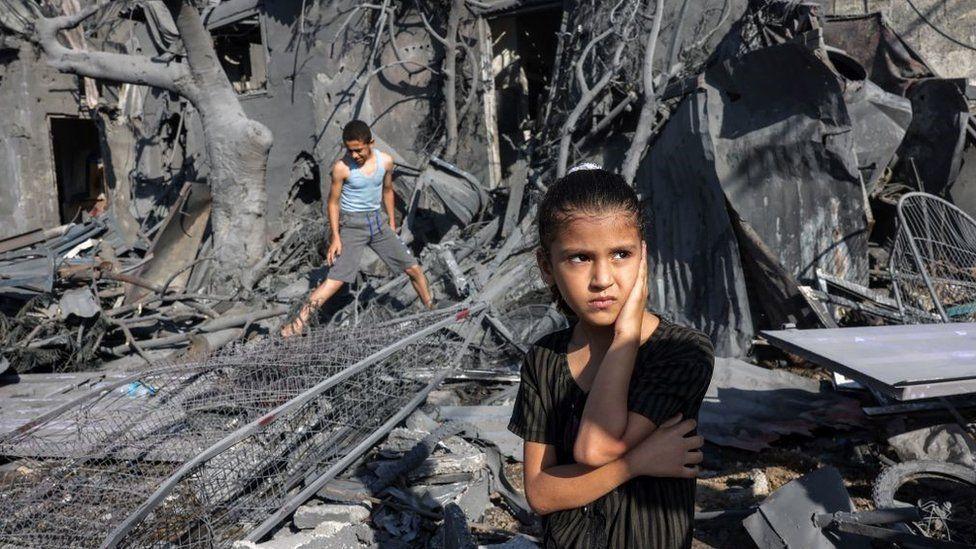 Niños palestinos frente a las ruinas en Gaza tras un bombardeo israelí