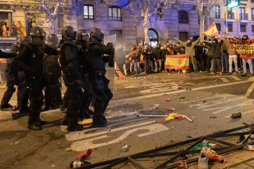 Manifestantes frente a un grupo de policías antidisturbios. 