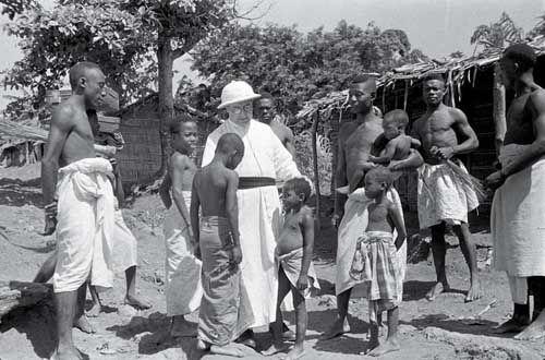 Un religioso rodeado de personas originarias de Guinea Ecuatorial. 