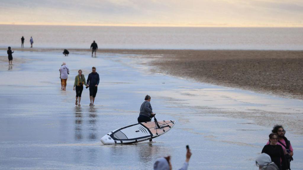 Los visitantes pasean con kayaks por la zona.