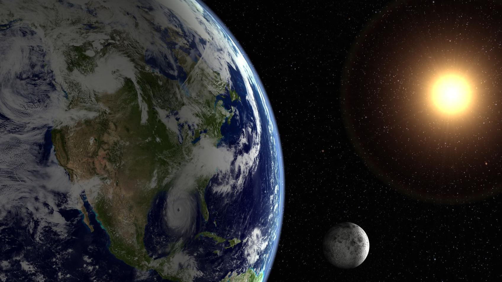 Imagen de la Tierra y a lo lejos el Sol y la Luna.