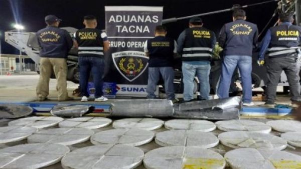 Policía de Perú junto a los discos de cocaína retenidos.