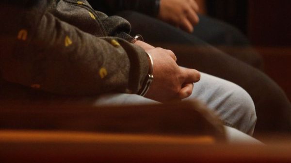 Manos de hombre con esposas tras ser detenido.