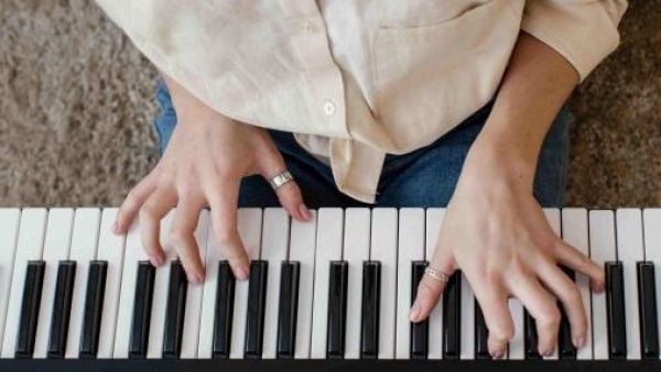 Person playing music on a keyboard