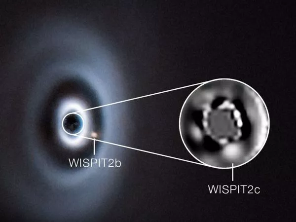 Representación de planetas en formación dentro de un disco de gas y polvo alrededor de una estrella joven.