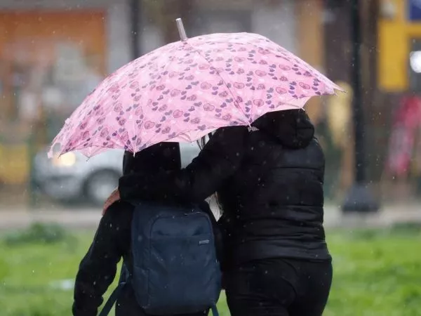 Personas bajo la lluvia con un paraguas