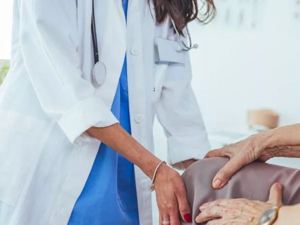 Adulta mayor siendo atendida por osteoartritis en su rodilla